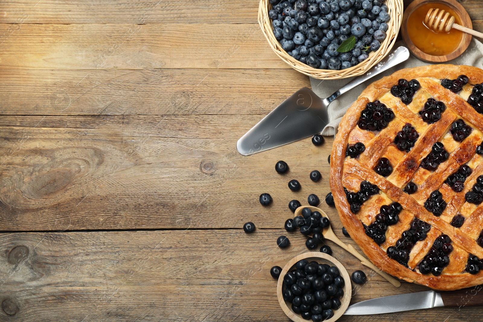 Photo of Tasty homemade pie with blueberries served on wooden table, flat lay. Space for text