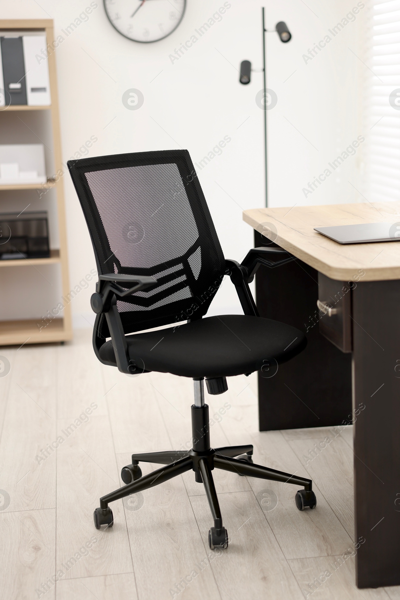 Photo of Black chair, laptop and desk in office