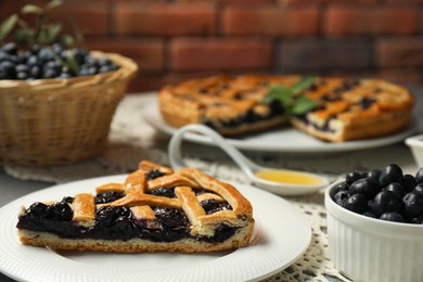 Photo of Piece of tasty homemade pie with blueberries on table, closeup