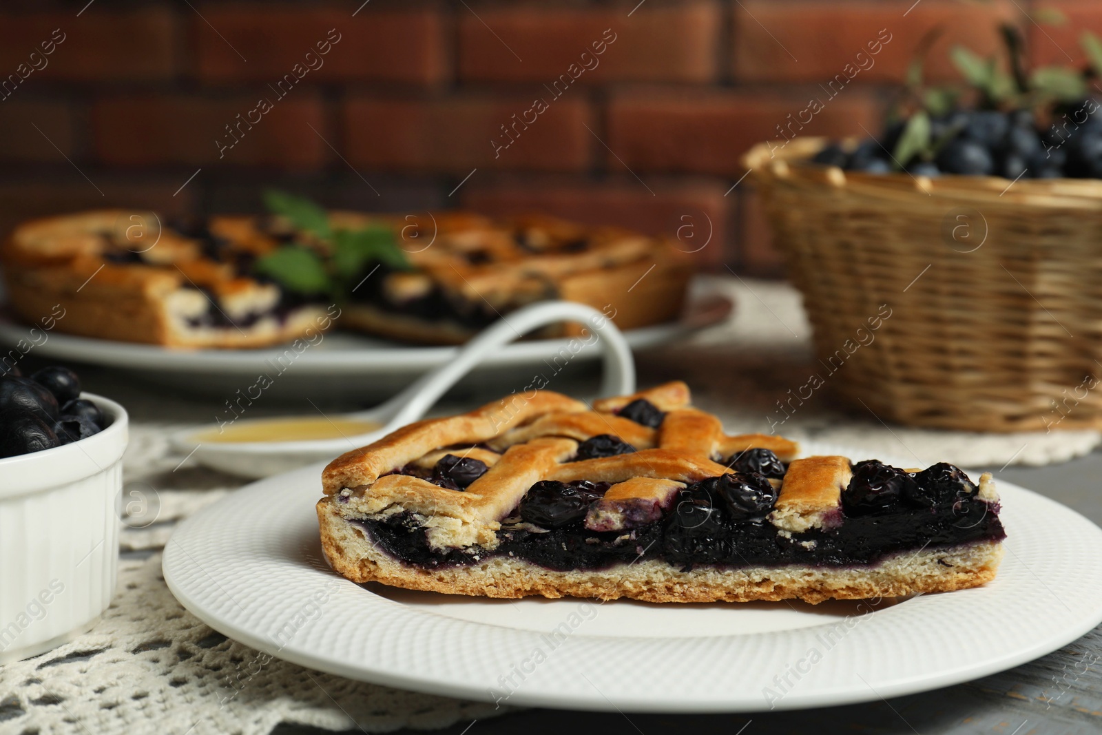 Photo of Piece of tasty homemade pie with blueberries on table, closeup