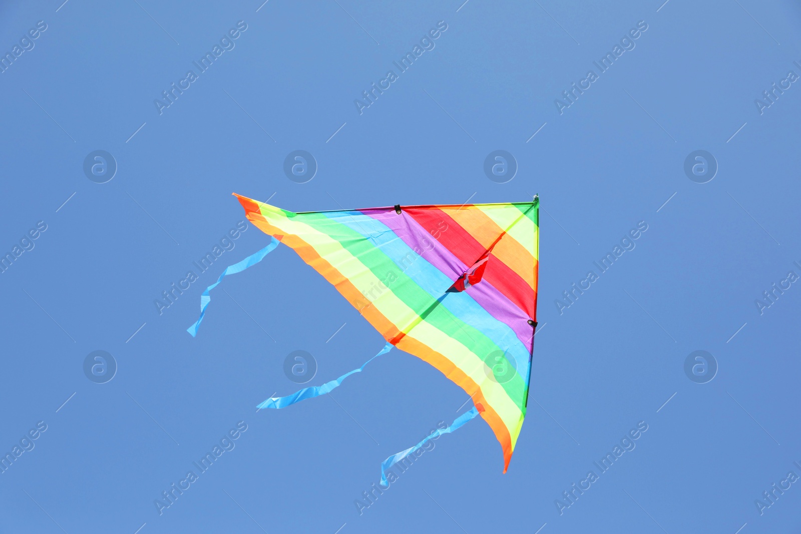 Photo of One colorful kite flying in blue sky