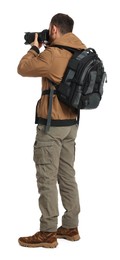 Photo of Photographer with backpack and camera taking picture on white background, back view