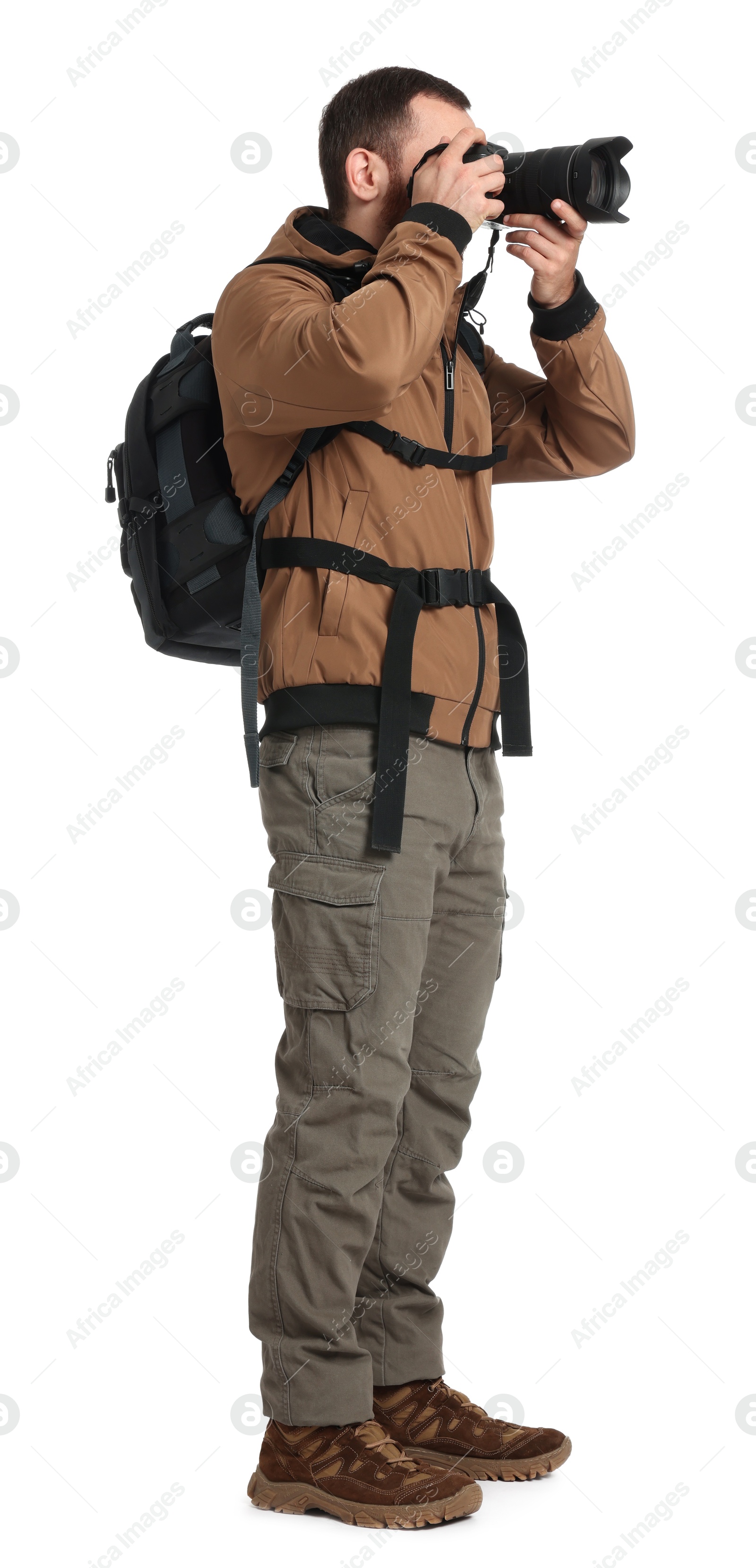 Photo of Photographer with backpack and camera taking picture on white background