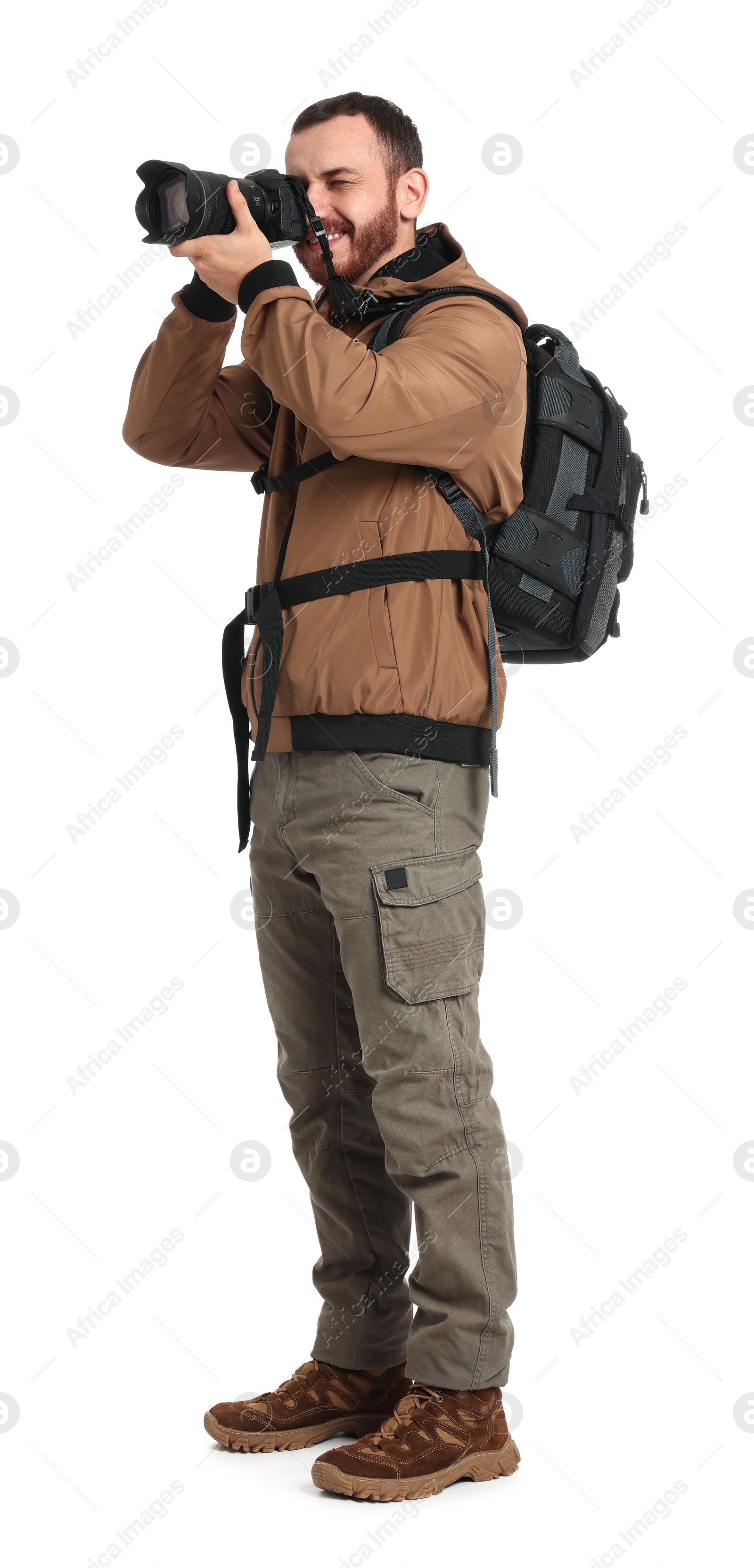 Photo of Photographer with backpack and camera taking picture on white background