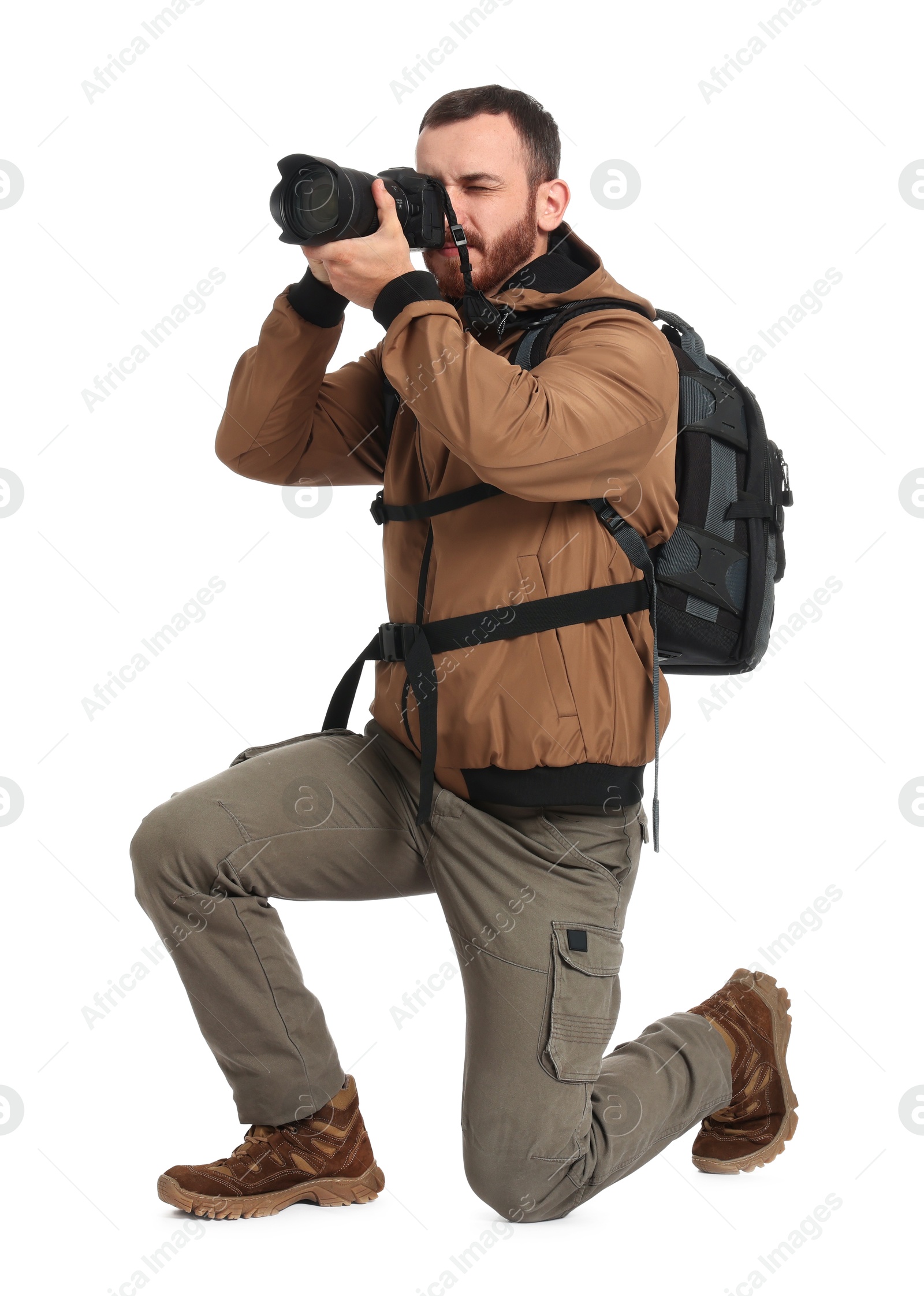 Photo of Photographer with backpack and camera taking picture on white background