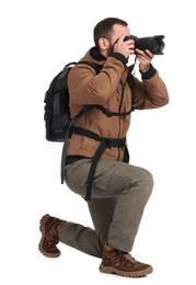 Photo of Photographer with backpack and camera taking picture on white background