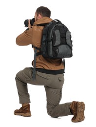 Photo of Photographer with backpack and camera taking picture on white background, back view