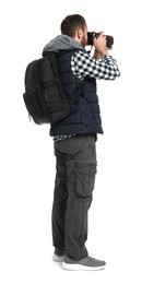 Photo of Photographer with backpack and camera taking picture on white background, back view