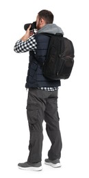 Photo of Photographer with backpack and camera taking picture on white background, back view