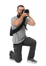 Photographer with backpack and camera taking picture on white background