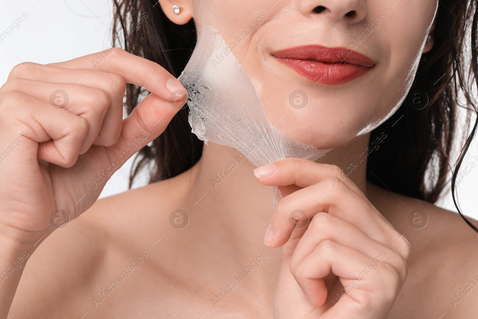 Photo of Woman peeling off face mask on white background, closeup