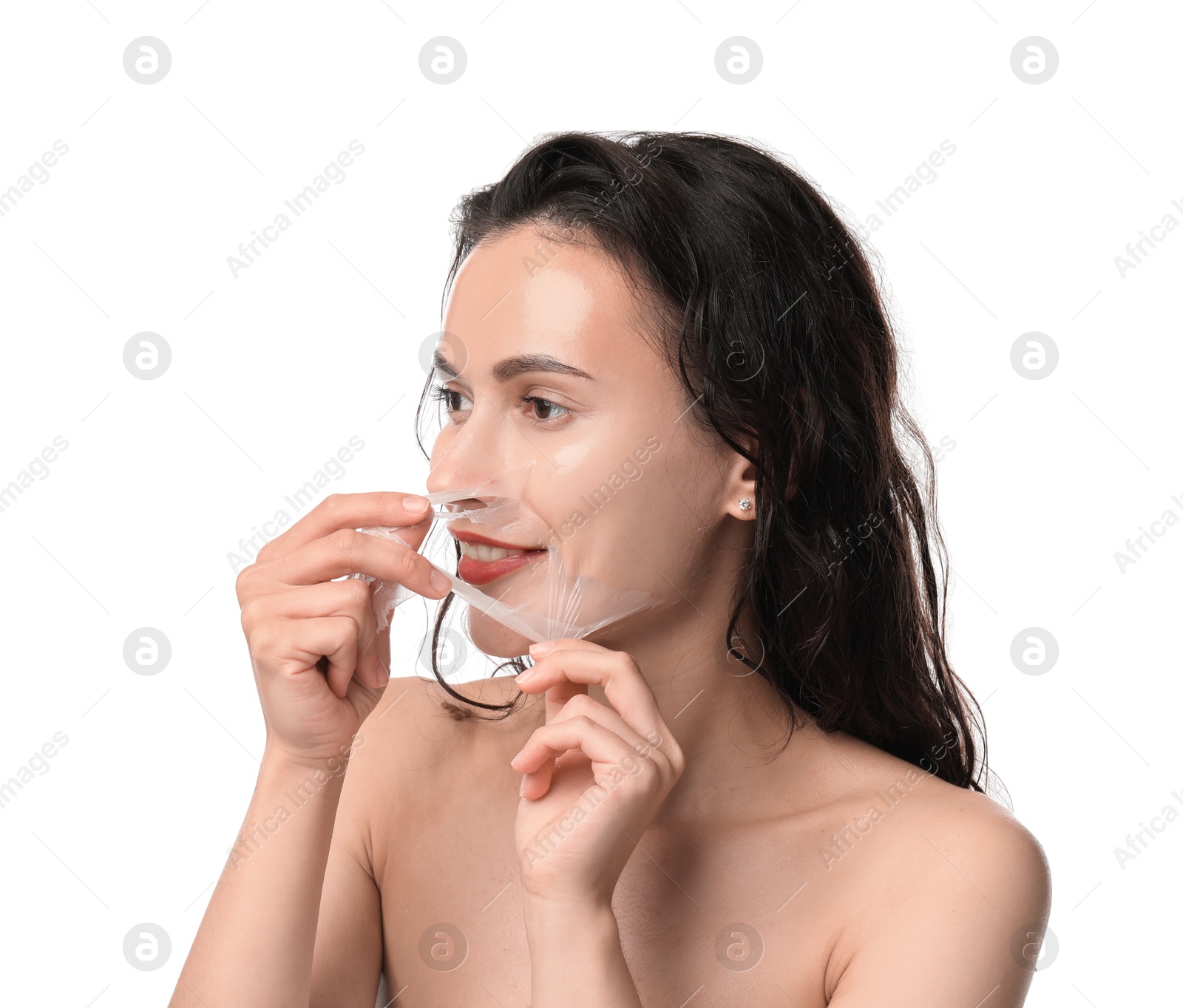 Photo of Smiling woman peeling off face mask on white background