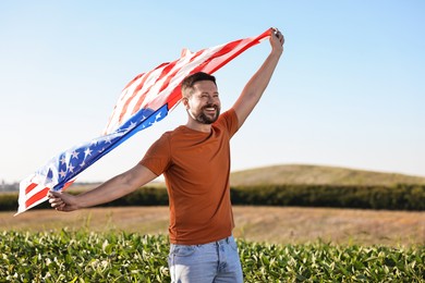 Happy man with flag of USA outdoors