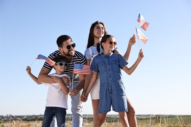 Happy family with flags of USA outdoors