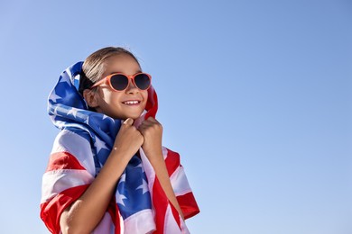 Photo of Happy girl with flag of USA outdoors. Space for text