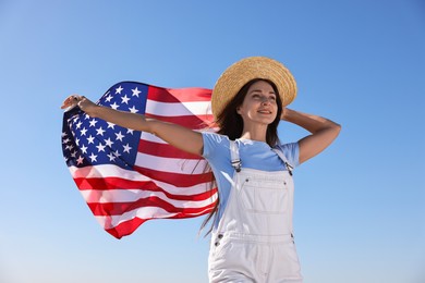 Photo of Happy woman with flag of USA outdoors