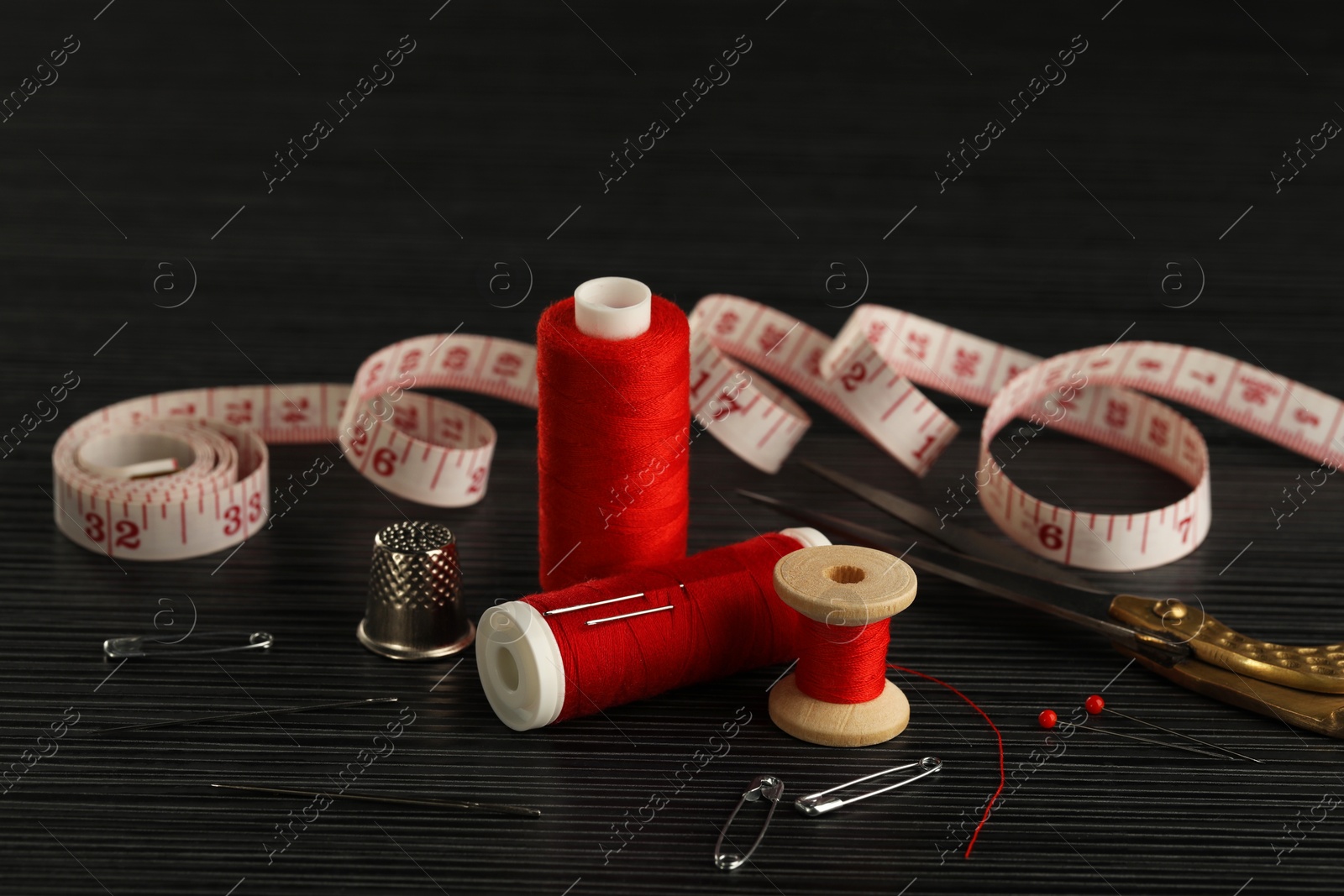 Photo of Many different sewing tools on wooden table