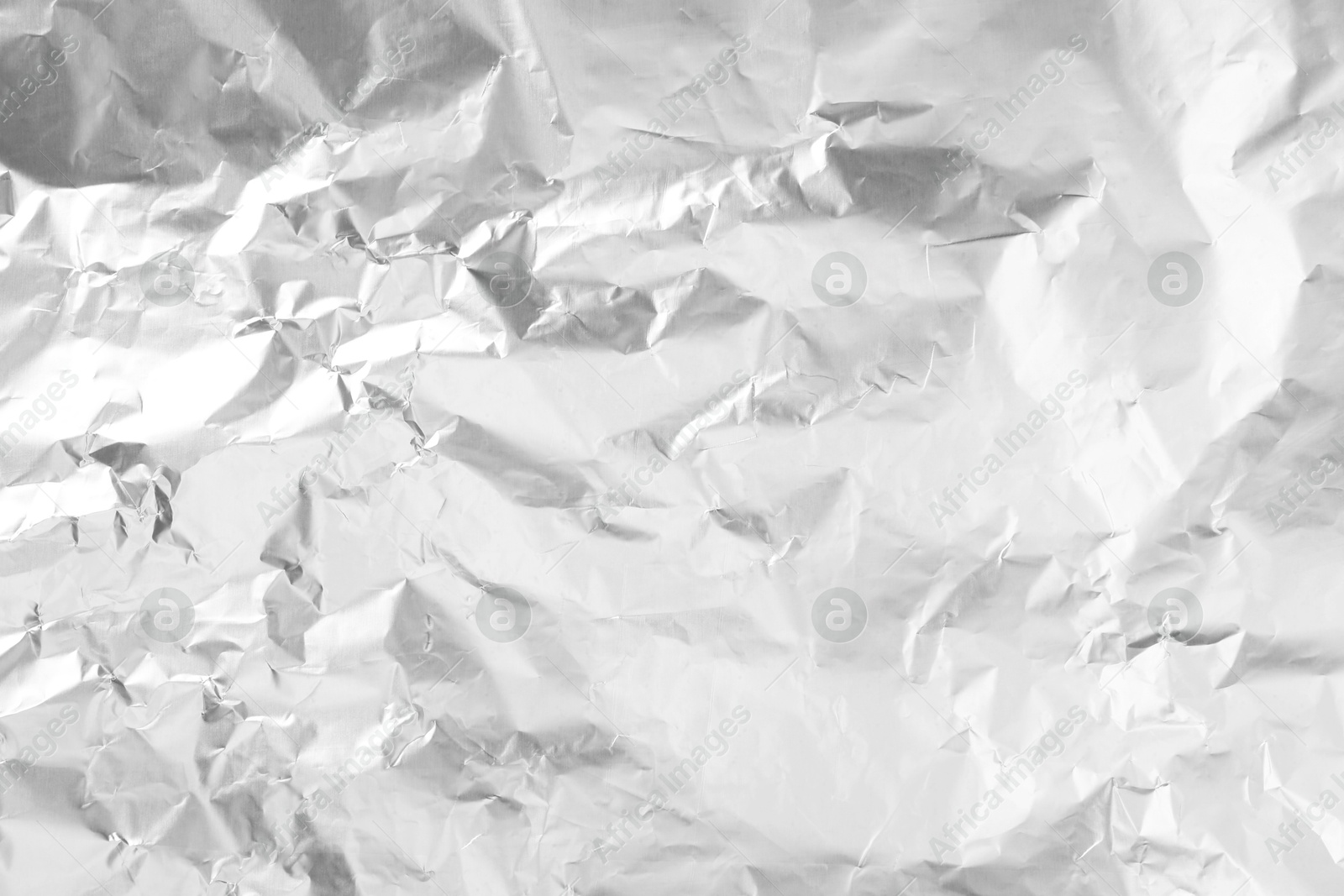 Photo of Shiny silver tinfoil surface as background, top view