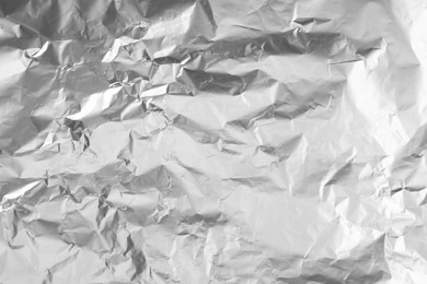 Photo of Shiny silver tinfoil surface as background, top view