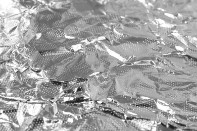 Photo of Shiny silver tinfoil surface as background, closeup