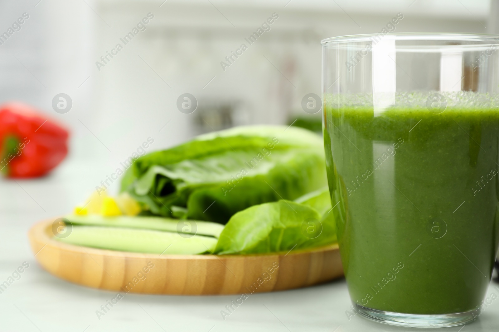 Photo of Delicious smoothie and ingredients on white table, closeup