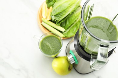 Modern blender with smoothie and ingredients on white marble table, above view. Space for text