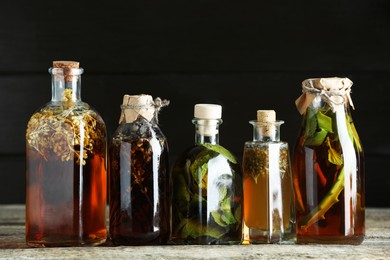 Photo of Different tinctures in bottles on wooden table