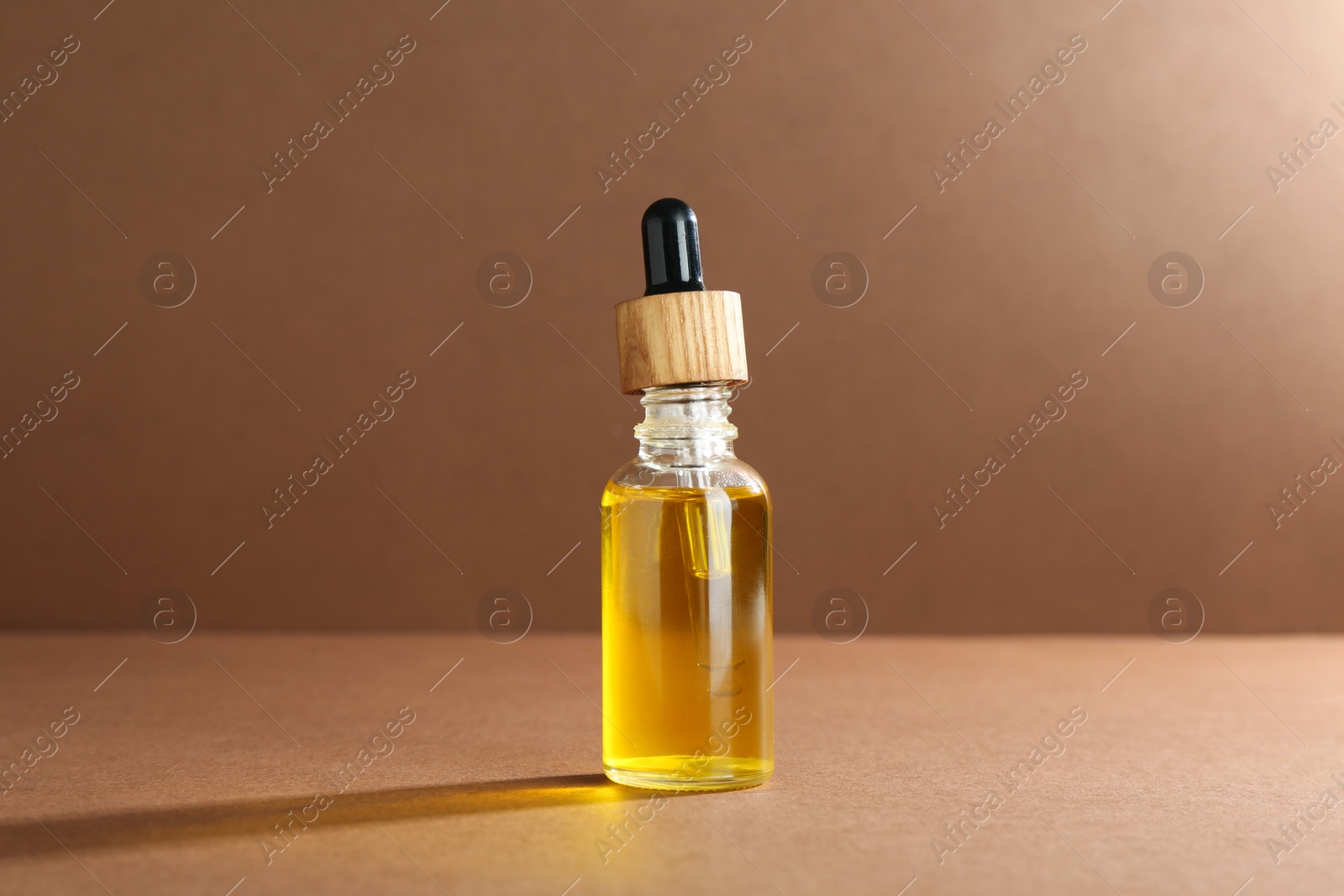 Photo of Natural tincture in bottle on beige background