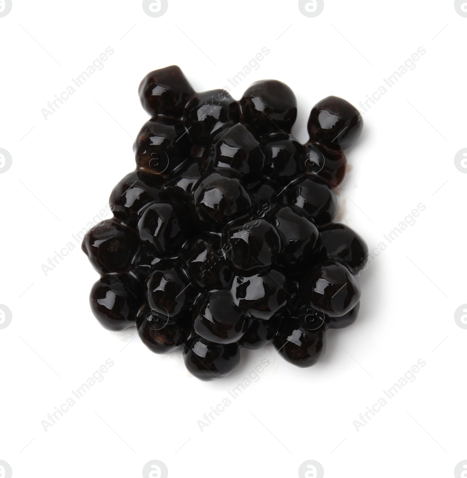 Photo of Pile of dark tapioca pearls isolated on white, top view