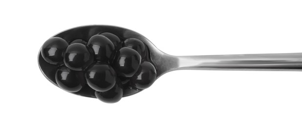 Photo of Dark tapioca pearls in spoon isolated on white, top view