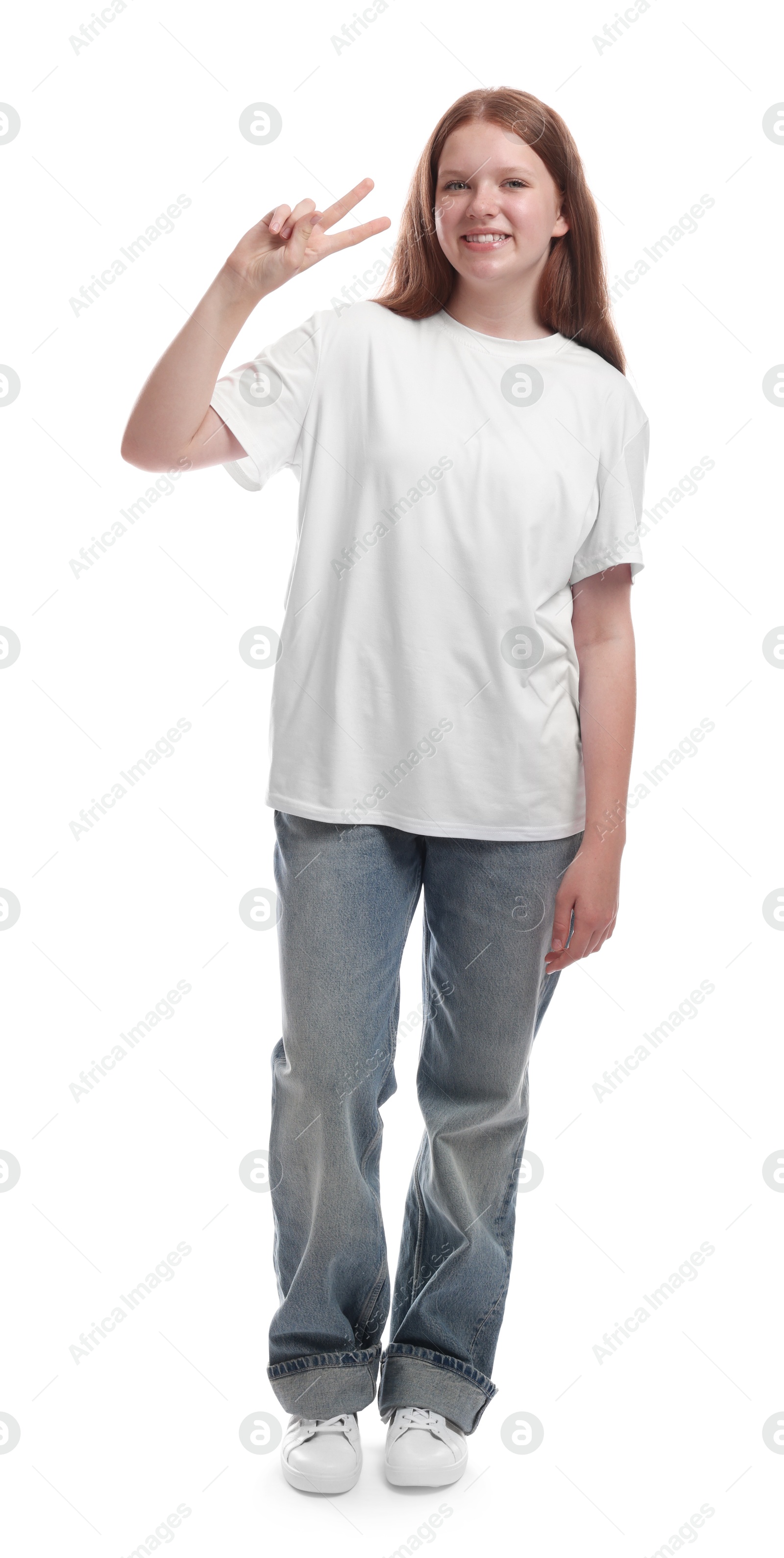 Photo of Teenage girl showing v-sign on white background