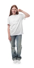 Photo of Teenage girl showing v-sign on white background