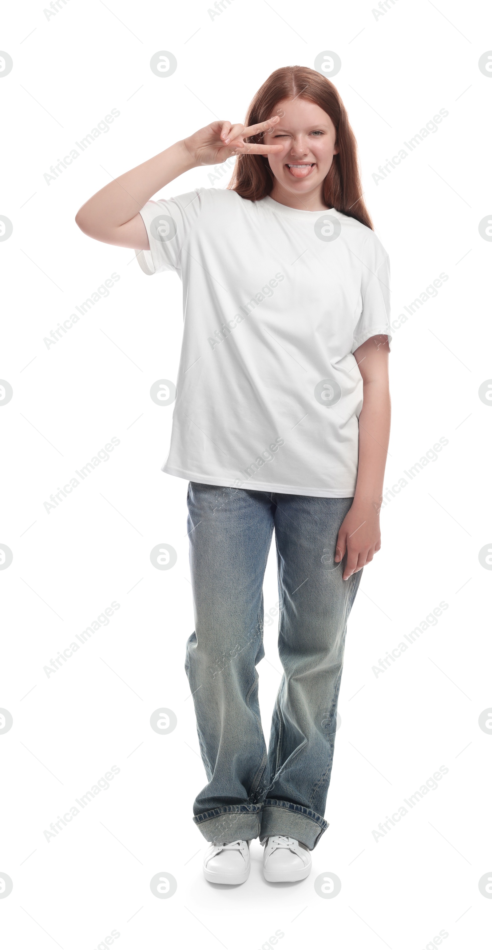 Photo of Teenage girl showing her tongue and v-sign on white background