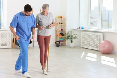 Photo of Senior patient exercising under physiotherapist supervision in rehabilitation center