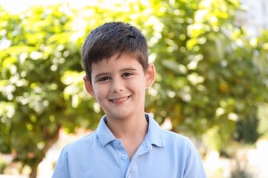 Photo of Portrait of little boy outdoors. Cute child