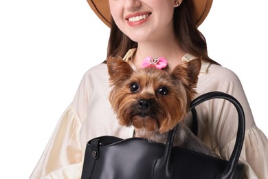 Photo of Young woman holding bag with cute Yorkshire Terrier dog isolated on white, closeup