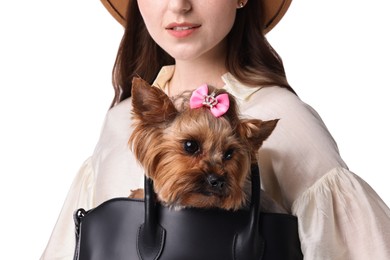 Young woman holding bag with cute Yorkshire Terrier dog isolated on white, closeup