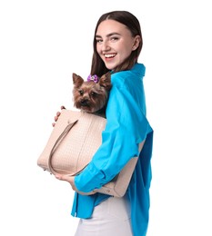 Beautiful young woman holding bag with cute Yorkshire Terrier dog isolated on white