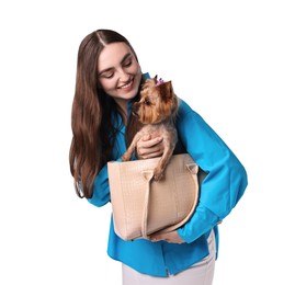 Photo of Beautiful young woman holding bag with cute Yorkshire Terrier dog isolated on white