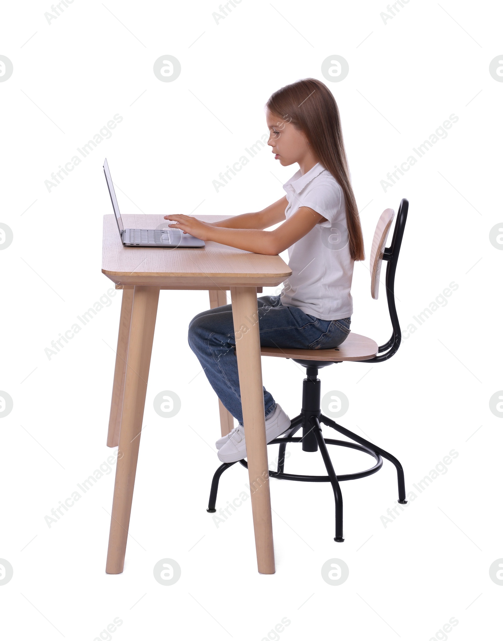 Photo of Girl with correct posture using laptop at wooden desk on white background