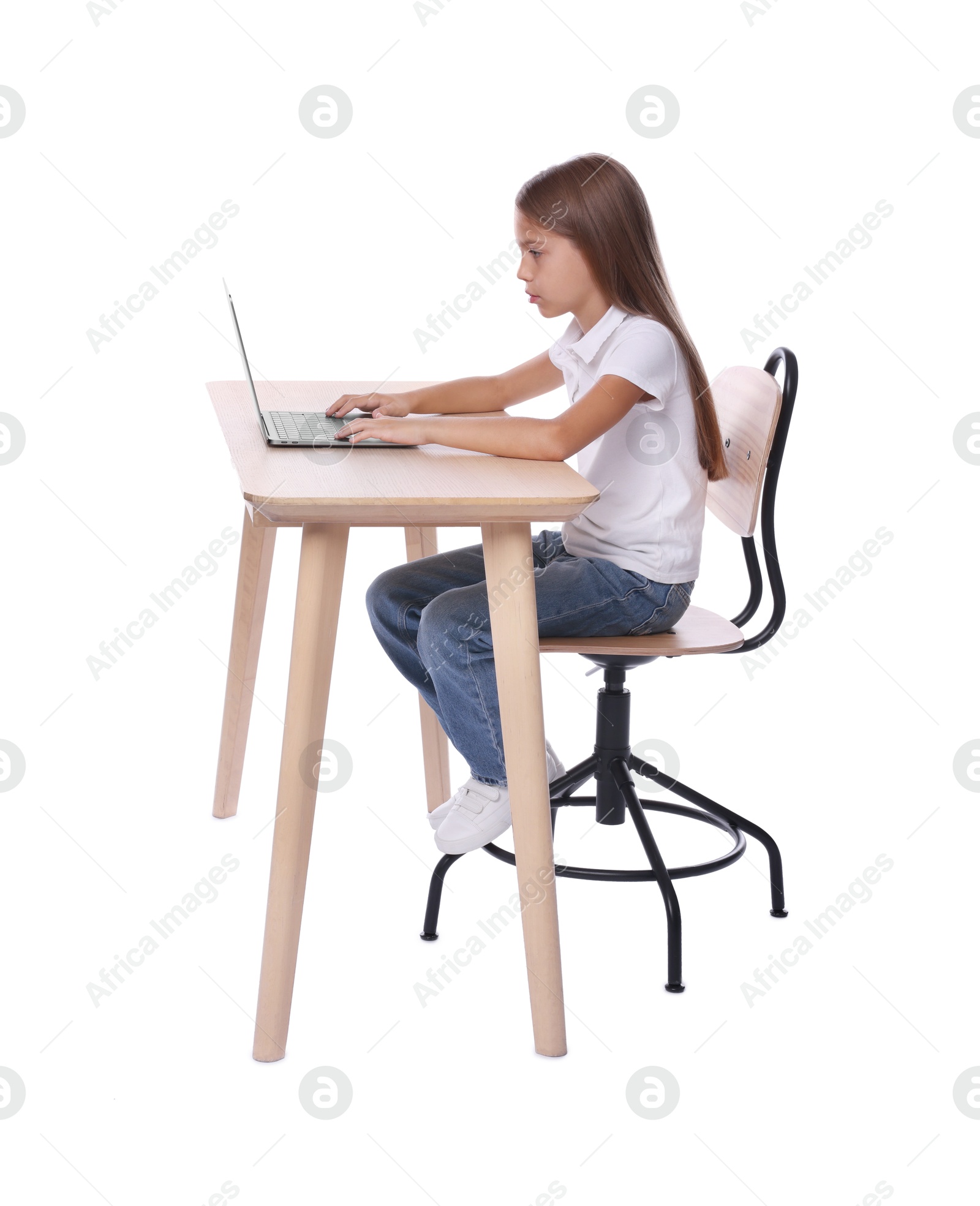 Photo of Girl with incorrect posture using laptop at wooden desk on white background