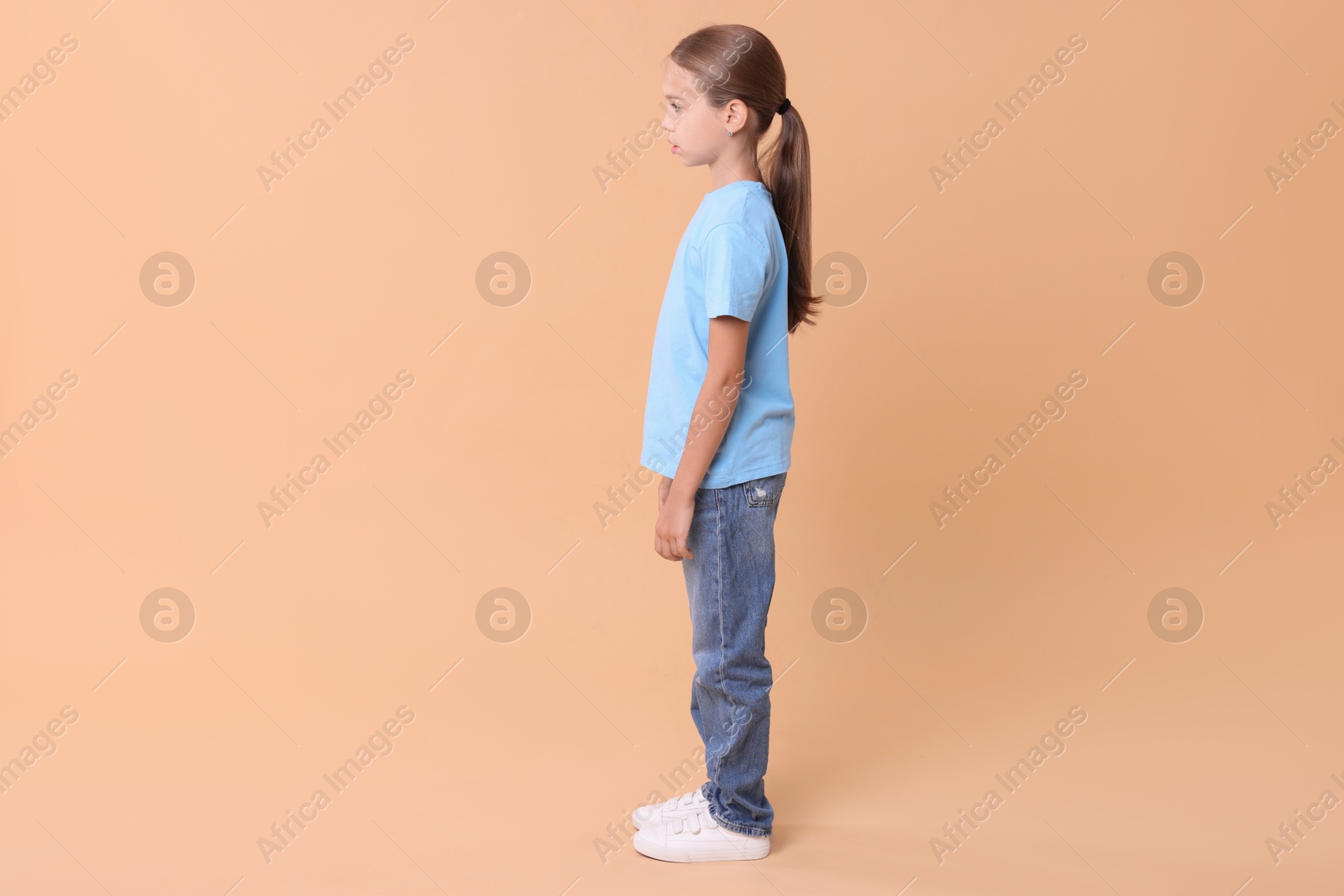 Photo of Girl with correct posture on beige background