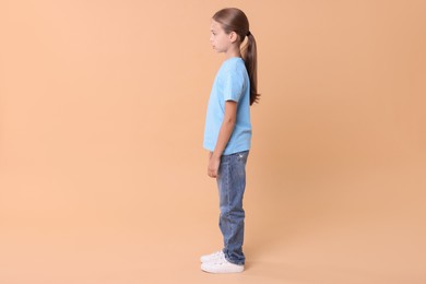 Girl with correct posture on beige background