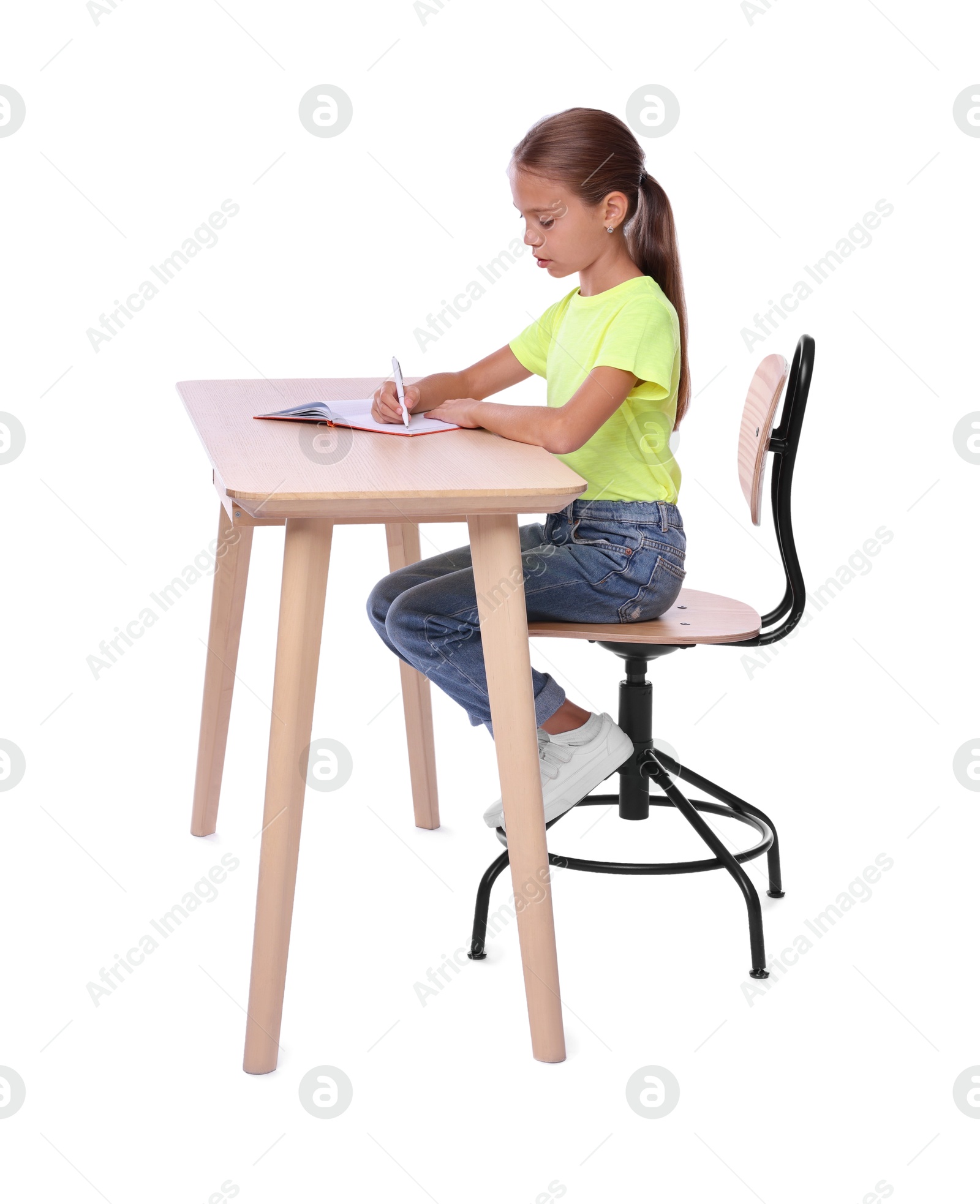 Photo of Girl with correct posture and notebook sitting at wooden desk on white background