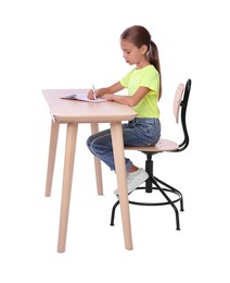 Photo of Girl with correct posture and notebook sitting at wooden desk on white background