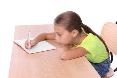 Photo of Girl with incorrect posture and notebook sitting at wooden desk on white background