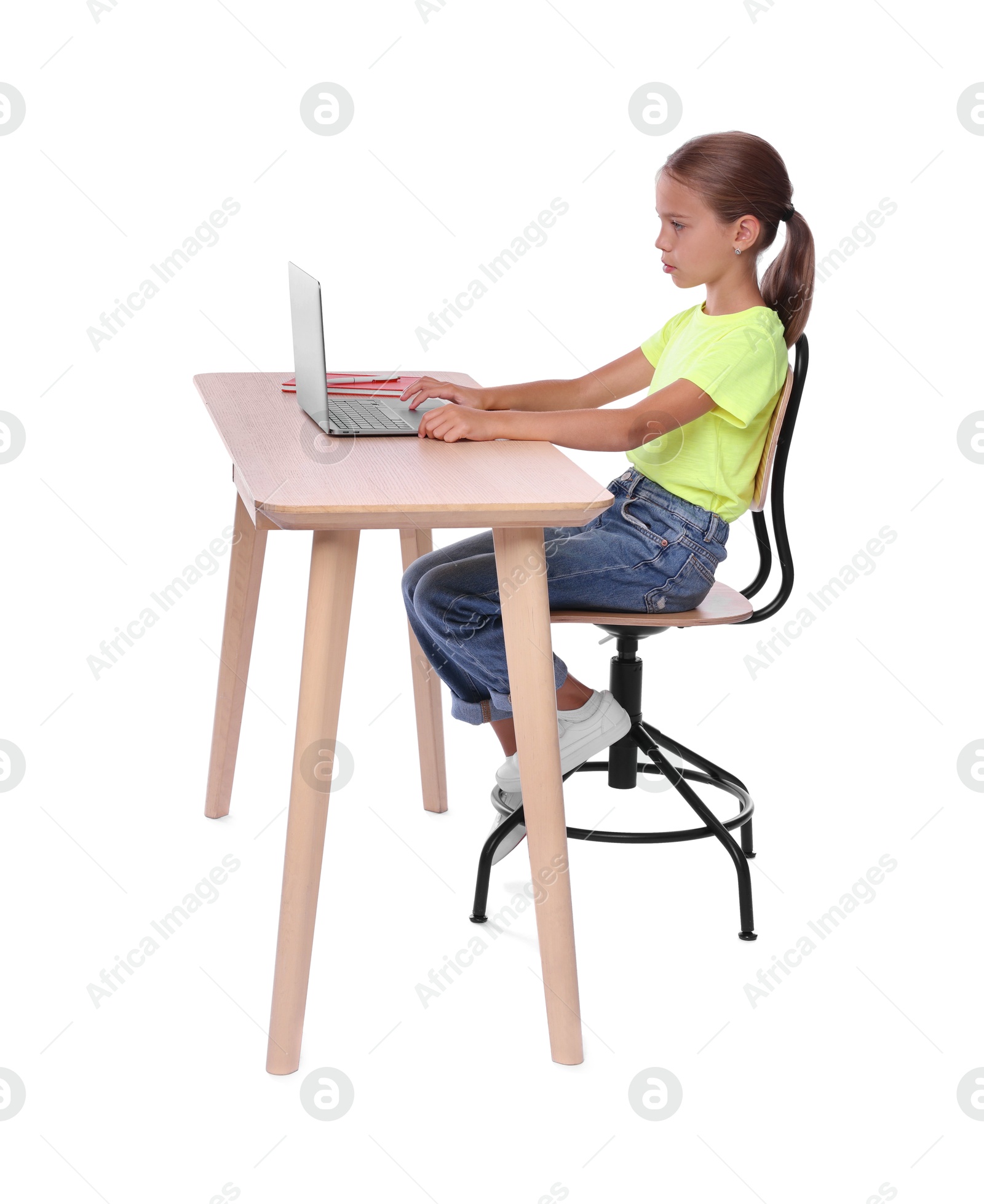 Photo of Girl with correct posture using laptop at wooden desk on white background