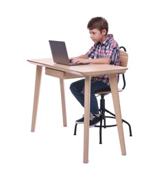 Boy with incorrect posture using laptop at wooden desk on white background