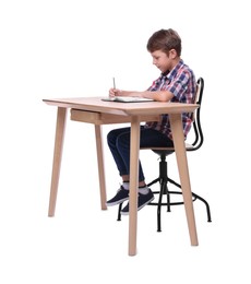 Photo of Boy with correct posture and notebook at wooden desk on white background