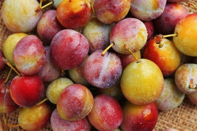 Photo of Tasty ripe plums on table, flat lay